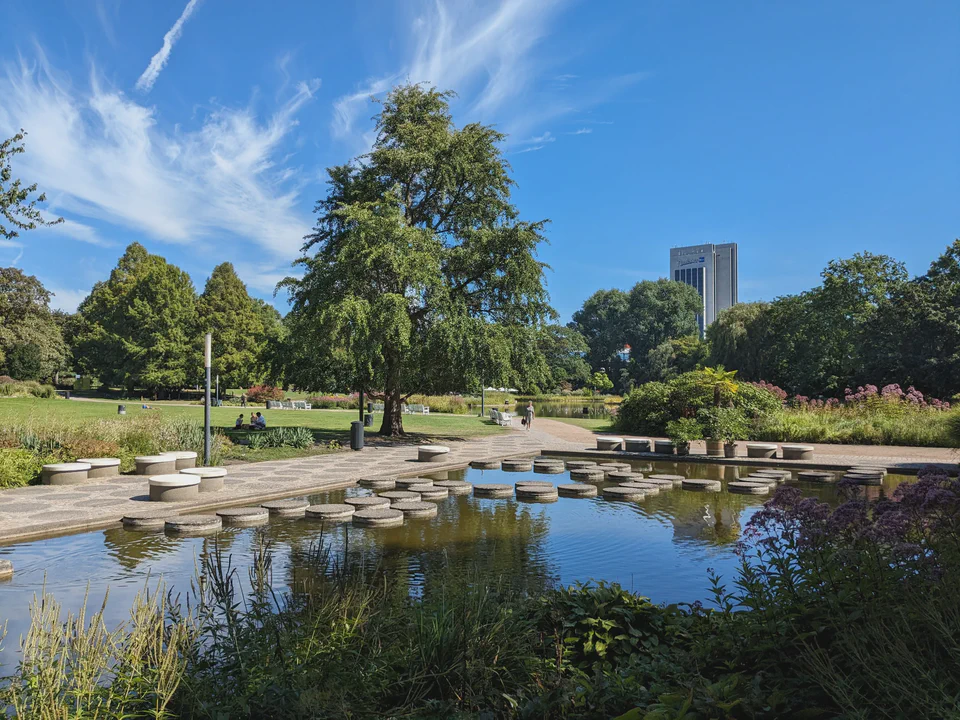 Picture of a pond at the Planten un Blomen part, with the blue sky reflecting in the water