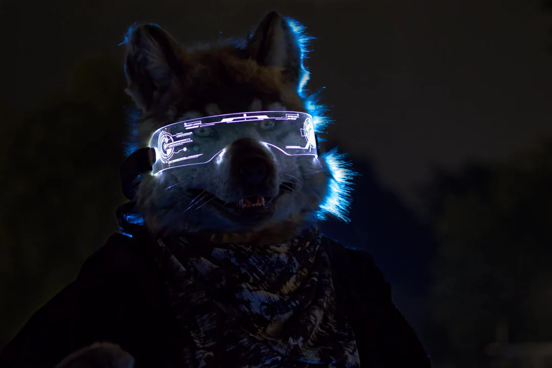 Close-up photo of a realistic wolf fursuiter wearing a cyberpunk visor, shot at night with a blue backlight