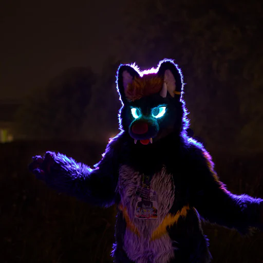 Photo of a dragon-wolf fursuiter with glowing blue eyes, arms raised slightly, lit with purple backlight.